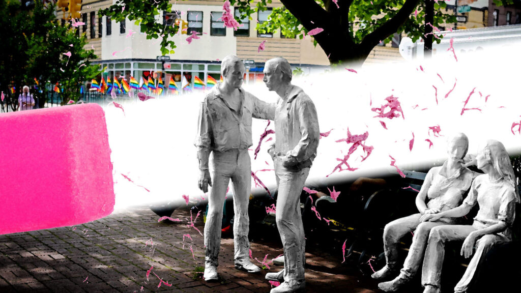 A pink eraser partially obscures a sculpture of four people. The sculpture is outdoors, surrounded by trees. A rainbow of pride flags is visible in the background, with pink fragments scattered in the air from the eraser.