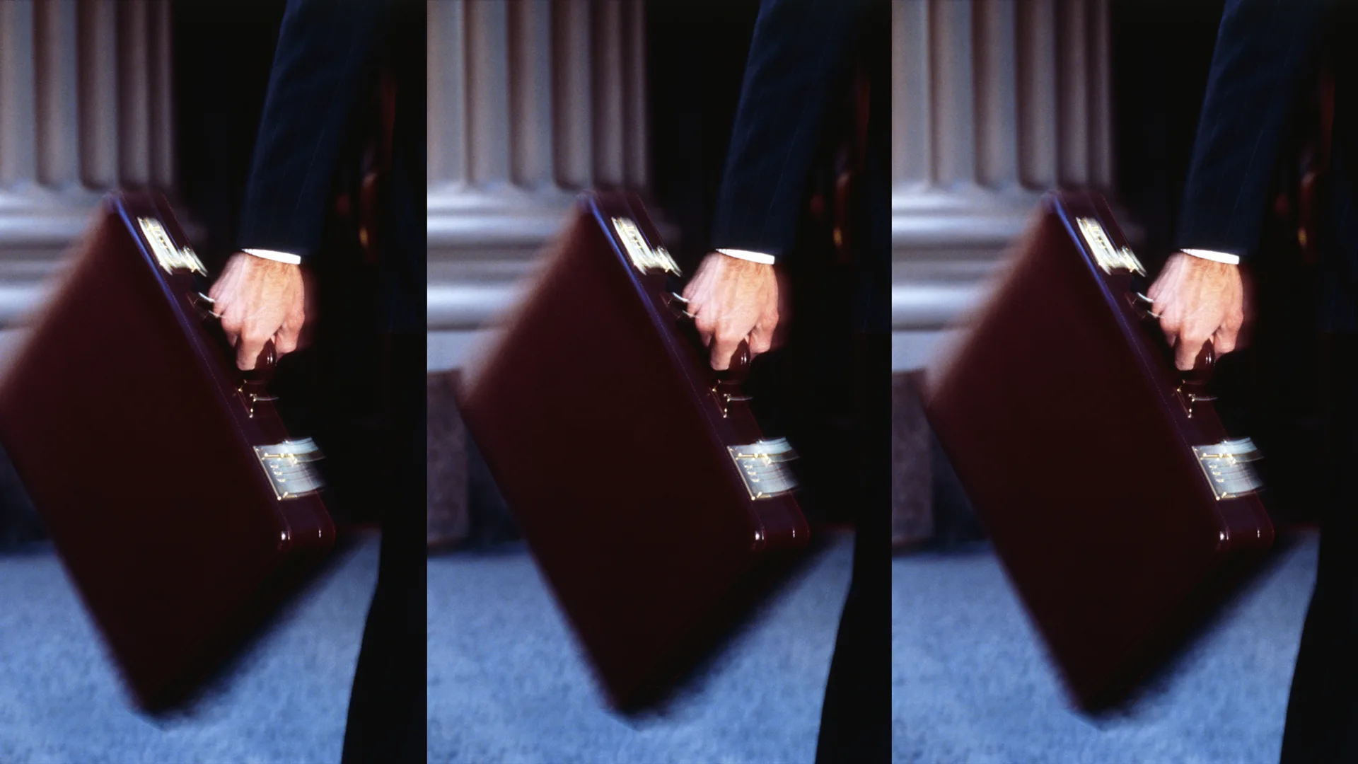 A person in a suit holding a briefcase, walking past large columns. The image is shown three times side by side in a blurred, motion effect.