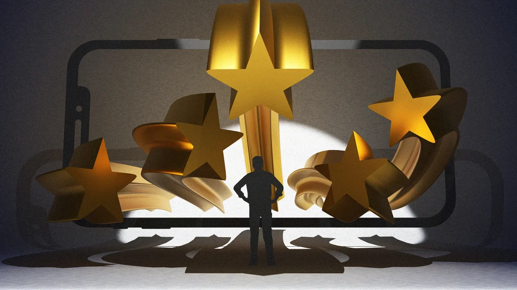 A silhouette of a person stands in front of a large smartphone screen, with several oversized golden stars emerging from the display, casting dramatic shadows.